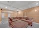 Spacious living room with plush sectional sofa and a coffered ceiling, perfect for relaxation at 1210 Spring Branch Ct, Lawrenceville, GA 30045