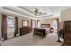 Spacious main bedroom boasts a trey ceiling, ceiling fan, and lots of natural light at 1210 Spring Branch Ct, Lawrenceville, GA 30045