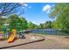 Community playground with slide and swingset, adjacent to a tennis court and green space at 1210 Spring Branch Ct, Lawrenceville, GA 30045