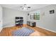 Neutral bedroom with wood floors, ceiling fan, desk with monitor, and natural light at 1683 Briarcliff Rd # 6, Atlanta, GA 30306
