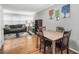 Open-concept dining area with wooden table, hardwood floors, and view into living room at 1683 Briarcliff Rd # 6, Atlanta, GA 30306