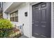 The front door to unit 6 is painted in a dark color, with a brass knocker and brick exterior at 1683 Briarcliff Rd # 6, Atlanta, GA 30306