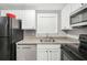 Well-lit kitchen with stainless steel dishwasher, black appliances, and ample cabinet space at 1683 Briarcliff Rd # 6, Atlanta, GA 30306