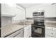 Bright kitchen featuring updated appliances, granite countertops, and ample storage at 1683 Briarcliff Rd # 6, Atlanta, GA 30306