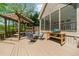 View of the deck with a dining table and chairs under a pergola, and a grill area adjacent to the house at 2675 Misty Morning Ln, Roswell, GA 30076