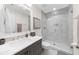Bright bathroom featuring a white marble shower, modern vanity with a stone countertop and a decorative mirror at 2675 Misty Morning Ln, Roswell, GA 30076