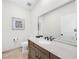 Stylish half-bathroom featuring custom vanity, sink, and a decorative mirror at 2675 Misty Morning Ln, Roswell, GA 30076