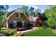 Attractive brick home showcasing well-maintained landscaping and brick walkway at 2675 Misty Morning Ln, Roswell, GA 30076