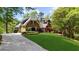 Charming brick home with lush landscaping, a circular driveway, and a well-manicured lawn at 2675 Misty Morning Ln, Roswell, GA 30076