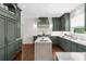Bright kitchen featuring stainless appliances, custom hood and countertops, and green cabinets at 2675 Misty Morning Ln, Roswell, GA 30076