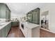 Bright open kitchen with island, marble countertops, green cabinetry and stainless appliances at 2675 Misty Morning Ln, Roswell, GA 30076