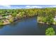 Aerial view of a lake surrounded by trees and homes in a residential neighborhood at 2675 Misty Morning Ln, Roswell, GA 30076