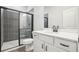 Modern bathroom featuring a glass enclosed shower and a white vanity with matte black hardware at 27 Kensington St, Kingston, GA 30145
