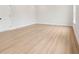 Spacious bedroom with wood-look floors and neutral color scheme, ready for personalization at 27 Kensington St, Kingston, GA 30145