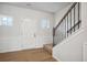 Inviting entryway has decorative wainscoting, stairs and wood-look flooring at 27 Kensington St, Kingston, GA 30145