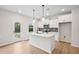 Bright kitchen features a central island, stainless appliances, white cabinetry, and pendant lighting at 27 Kensington St, Kingston, GA 30145
