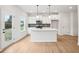 Well-designed kitchen features white cabinets, island with seating, and stainless steel appliances at 27 Kensington St, Kingston, GA 30145