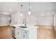 Spacious living area flows into the kitchen with island and stainless steel appliances at 27 Kensington St, Kingston, GA 30145