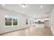 Open-concept living space showcases large windows and flows seamlessly into the modern kitchen at 27 Kensington St, Kingston, GA 30145