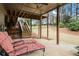 Covered back patio seating area with stairs leading to the yard at 45 Cherrystone Walk, Suwanee, GA 30024