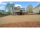 Large backyard with a tiered deck and patio area at 45 Cherrystone Walk, Suwanee, GA 30024