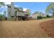 Spacious backyard featuring lush green grass and mature trees at 45 Cherrystone Walk, Suwanee, GA 30024