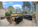 Back deck overlooking a grassy yard with mature trees at 45 Cherrystone Walk, Suwanee, GA 30024