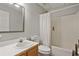 Bright full bathroom featuring a shower-tub combo, white tile, and modern fixtures at 45 Cherrystone Walk, Suwanee, GA 30024