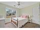 Comfortable bedroom featuring a window view and a neutral color palette with plush carpeting at 45 Cherrystone Walk, Suwanee, GA 30024