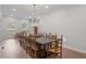 Large dining room features an extra long wood table, wood chairs, and bright natural light at 45 Cherrystone Walk, Suwanee, GA 30024