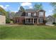 Beautiful brick two-story home with a manicured lawn, classic shutters, and charming front porch at 45 Cherrystone Walk, Suwanee, GA 30024