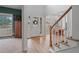 Bright foyer featuring hardwood floors, a staircase, and views into the dining and Gathering room at 45 Cherrystone Walk, Suwanee, GA 30024