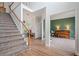 Entryway with hardwood floors, a staircase, and views into the adjacent rooms at 45 Cherrystone Walk, Suwanee, GA 30024