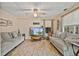 Comfortable living room featuring two gray sofas, a ceiling fan, and wood-look flooring at 45 Cherrystone Walk, Suwanee, GA 30024