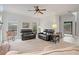 Spacious living room with plush seating, and large windows overlooking the yard at 45 Cherrystone Walk, Suwanee, GA 30024