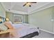 Large main bedroom with a view, a ceiling fan, neutral paint, and plush gray carpeting at 45 Cherrystone Walk, Suwanee, GA 30024