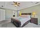 Spacious main bedroom featuring a trey ceiling, ceiling fan, and neutral color palette at 45 Cherrystone Walk, Suwanee, GA 30024