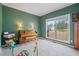 Cozy room with a piano, large windows, and soft carpet at 45 Cherrystone Walk, Suwanee, GA 30024
