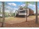 Spacious backyard with a mix of grass and pine straw, features a fire pit and mature trees at 6935 York Pl, Cumming, GA 30040