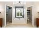 Stylish bathroom featuring a soaking tub, glass enclosed shower, and modern fixtures at 6935 York Pl, Cumming, GA 30040