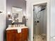 Elegant bathroom vanity with dark wood cabinet, marble countertop, and a glass enclosed shower at 6935 York Pl, Cumming, GA 30040