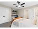 Comfortable bedroom with built-in desk space, neutral tones, and modern ceiling fan at 6935 York Pl, Cumming, GA 30040