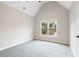 Vaulted ceiling bedroom with neutral carpet and large windows offering outdoor views at 6935 York Pl, Cumming, GA 30040