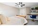 Comfortable bedroom with built-in desk space, neutral tones, and modern ceiling fan at 6935 York Pl, Cumming, GA 30040