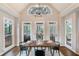 Bright dining area featuring stylish chandelier and direct access to screened in porch at 6935 York Pl, Cumming, GA 30040