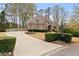 Charming home with manicured lawn, mature trees and a well-maintained driveway and mailbox at 6935 York Pl, Cumming, GA 30040