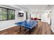 Basement recreation room featuring a ping pong table with a TV at 6935 York Pl, Cumming, GA 30040