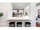 Modern kitchen features a breakfast bar with marble countertops and sleek black stools at 6935 York Pl, Cumming, GA 30040
