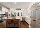 Open kitchen with a central island, stainless appliances, hardwood floors and eat-in seating at 6935 York Pl, Cumming, GA 30040