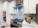 Bright kitchen with stainless steel appliances, gas cooktop, and stylish backsplash tiles at 6935 York Pl, Cumming, GA 30040